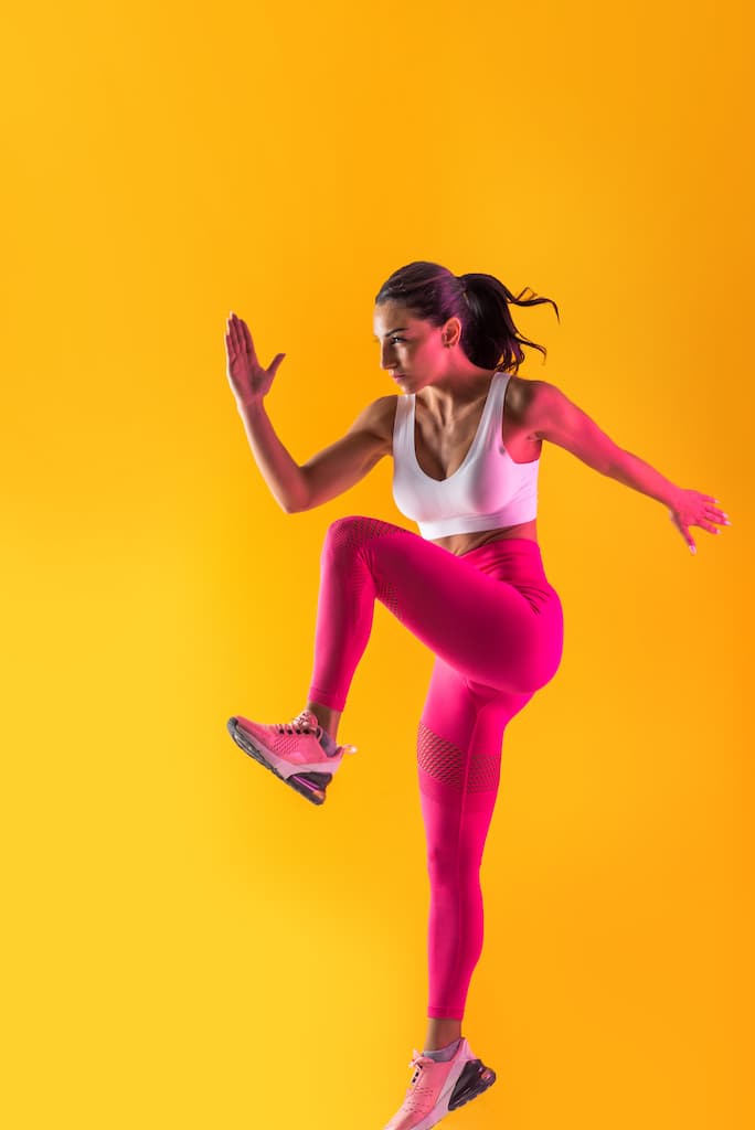 Athlete mid-stride during a conditioning circuit.